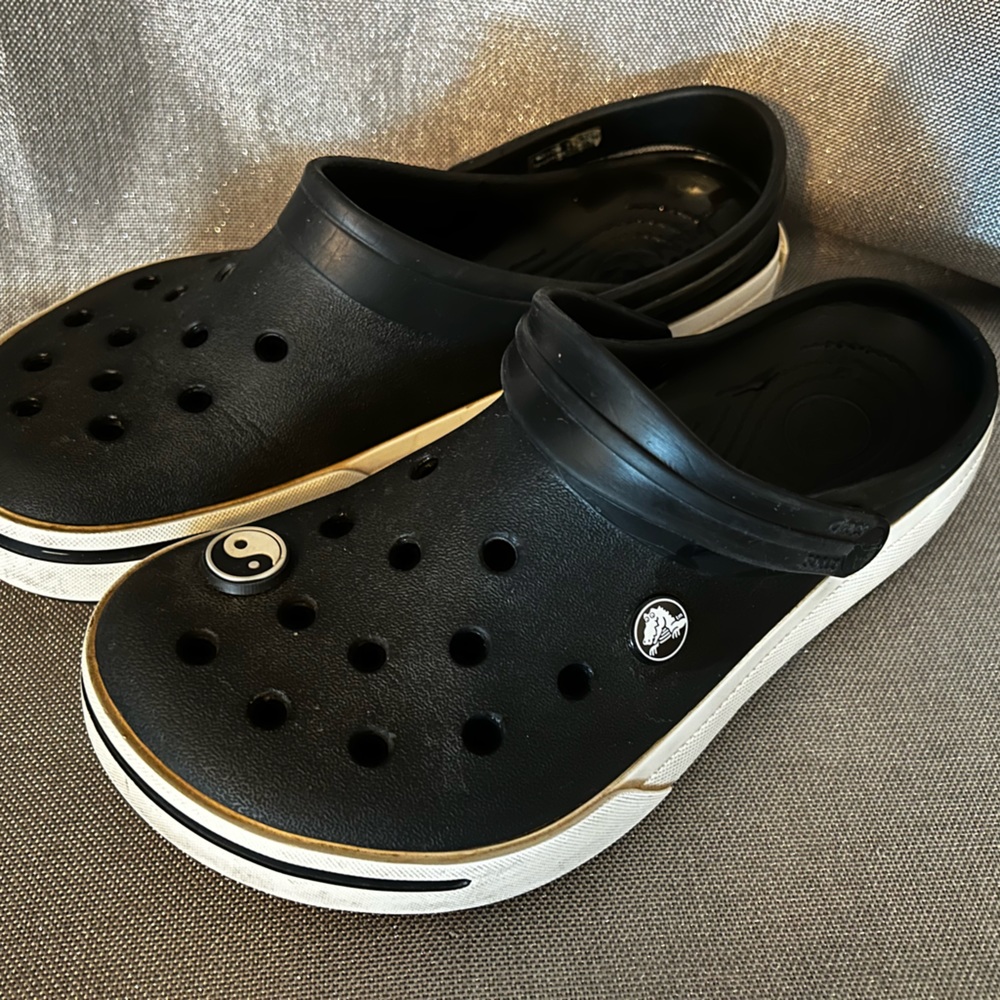 Crocs. Black & white. Women’s 9, men’s 7.